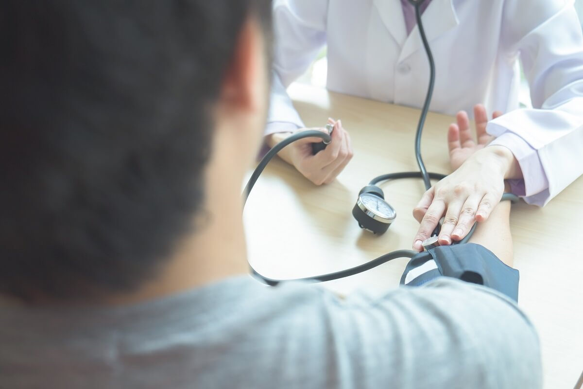 Doctor checking patient arterial blood pressure